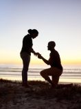 Silhouette of a man proposing to a woman.