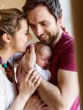 Parents holding newborn.