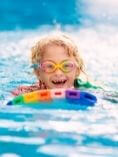 Young child swimming in a pool