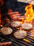 Grill with burgers and hot dogs