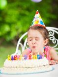 Kid Blowing Out Birthday Candles