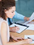 Woman studying document.