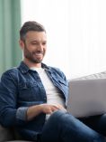 Happy man sitting with laptop