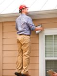 Man Inspecting Roof