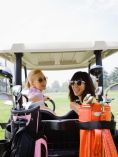 Two girls on a golf cart