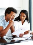 Couple studying paperwork.