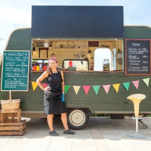 Food truck owner standing in front of food truck.