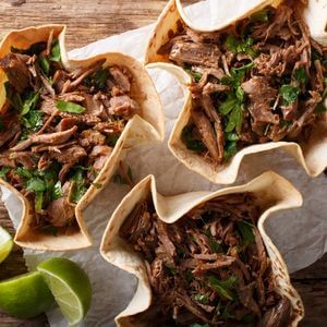 Photo of barbacoa beef in taco shell bowls