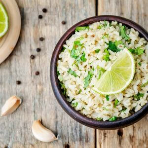 Photo of a bowl of cilantro lime rice with a lime on top