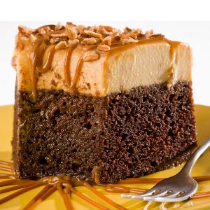 Photo of a chocolate cake with whipped topping and caramel sauce