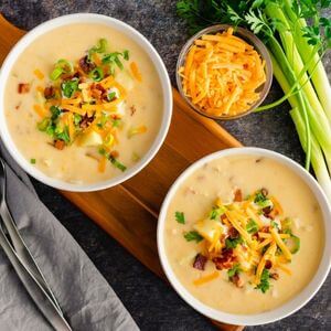 Photo of loaded baked potato soup with cheese, bacon, and green onion on top
