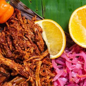 A Photo of pulled pork with pickled onions