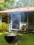 Grill in yard of house.