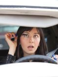 Woman applying makeup while driving her car