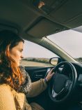 Woman driving drowsily in her car