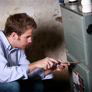 Man preparing to work on home furnace