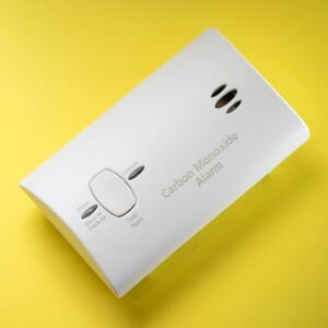 Carbon monoxide detector on a yellow background