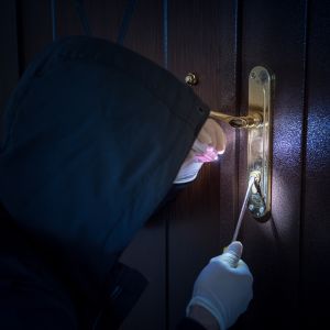 Burglar attempting to break in through front door