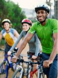 Young adults riding bikes.